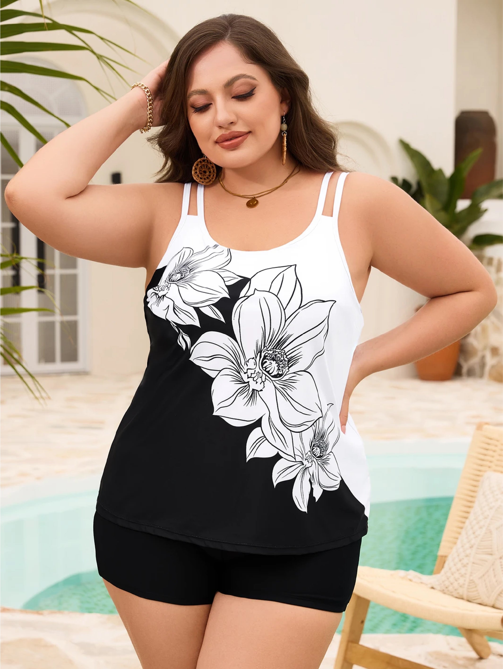 A woman wearing a black and white floral swimsuit